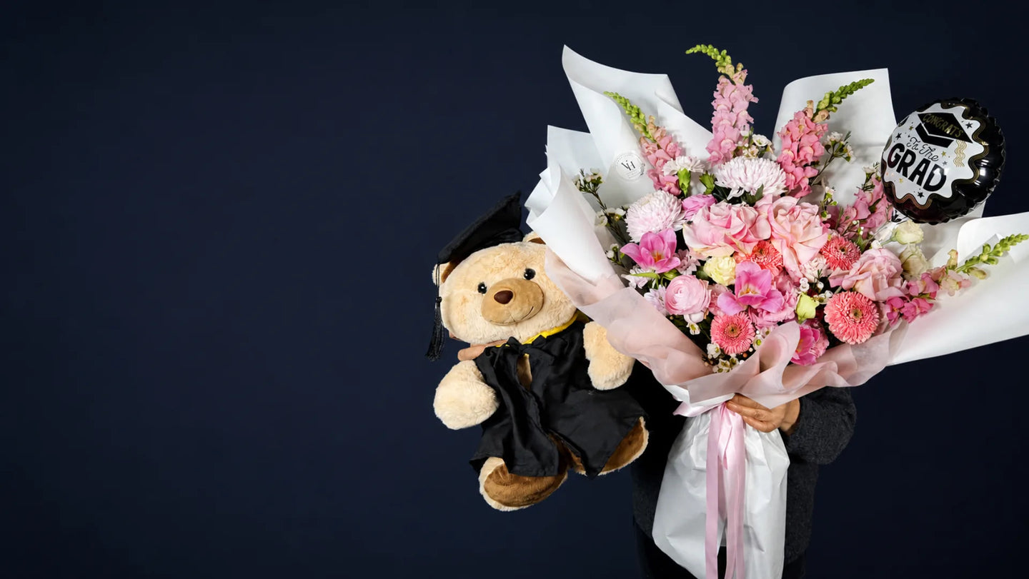 Pink graduation flower bouquet with graduate teddy and celebration balloon by Vhouse Florist