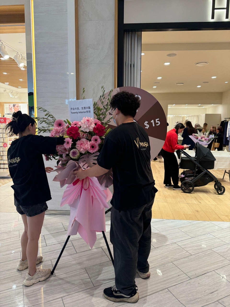 Vhouse Florist team preparing a large pink flower arrangement