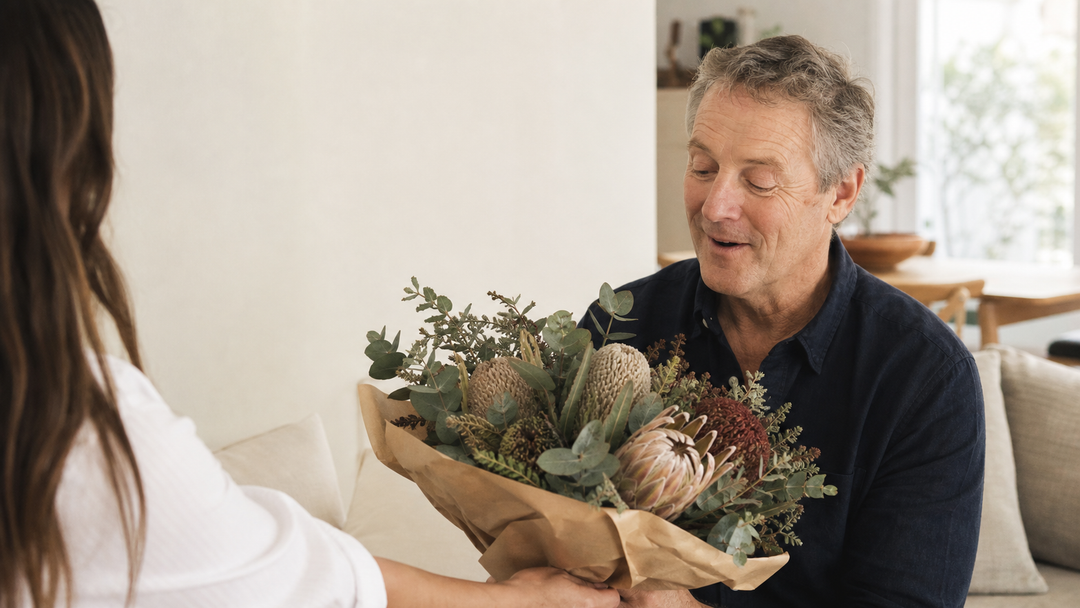A father receiving an Australian native flower bouquet for Father's Day