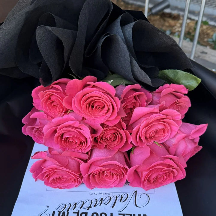 12 hot pink roses bouquet overhead view wrapped in black paper with romantic gift card, Sydney same-day luxury hot pink rose delivery by Vhouse Florist