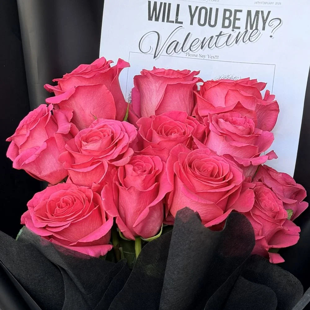 Close-up of 12 hot pink roses bouquet in black paper wrap with romantic gift card, Sydney same-day luxury hot pink rose delivery by Vhouse Florist
