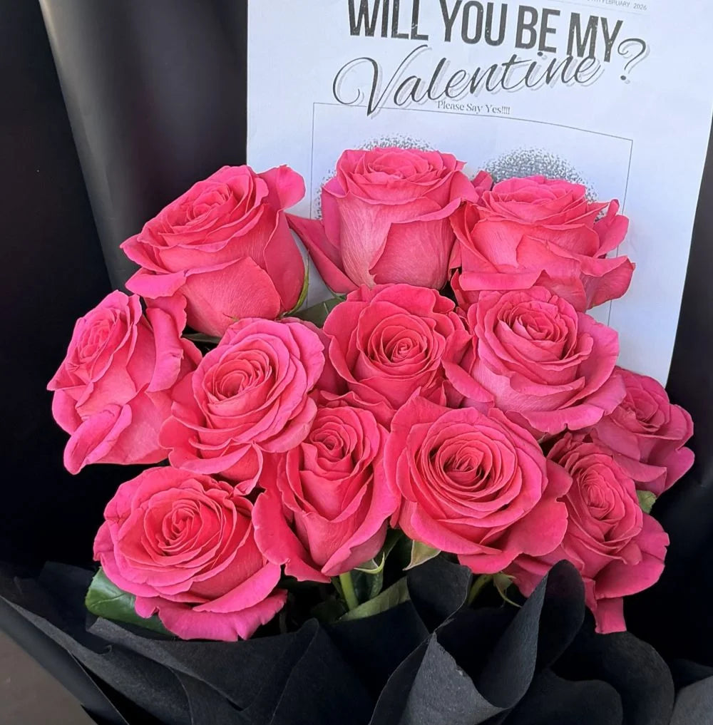 Close-up of 12 hot pink roses bouquet in black paper wrap with romantic gift card, Sydney same-day luxury hot pink rose delivery by Vhouse Florist