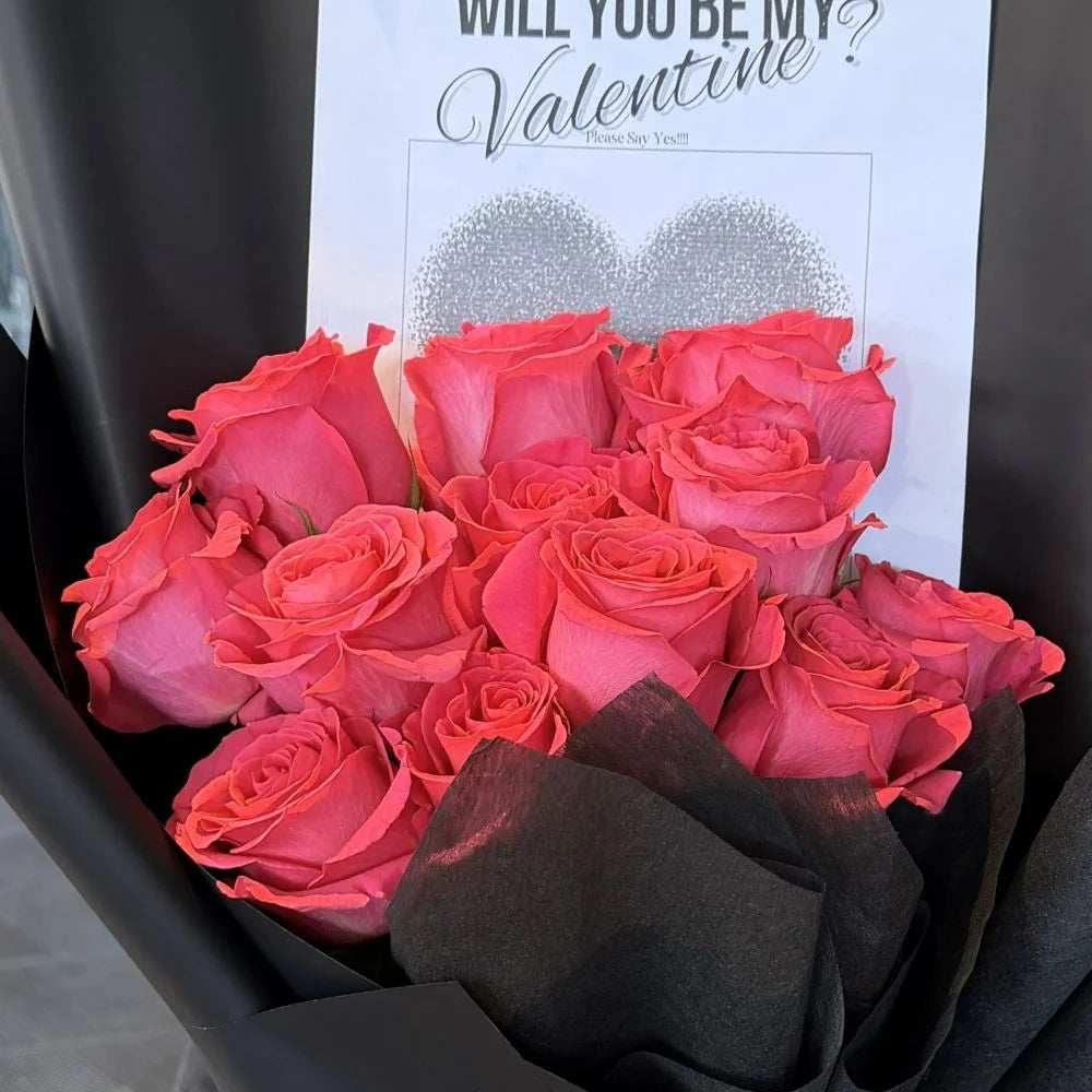 Close-up of 12 hot pink roses bouquet in black paper with romantic heart gift card, Sydney same-day luxury hot pink rose delivery by Vhouse Florist