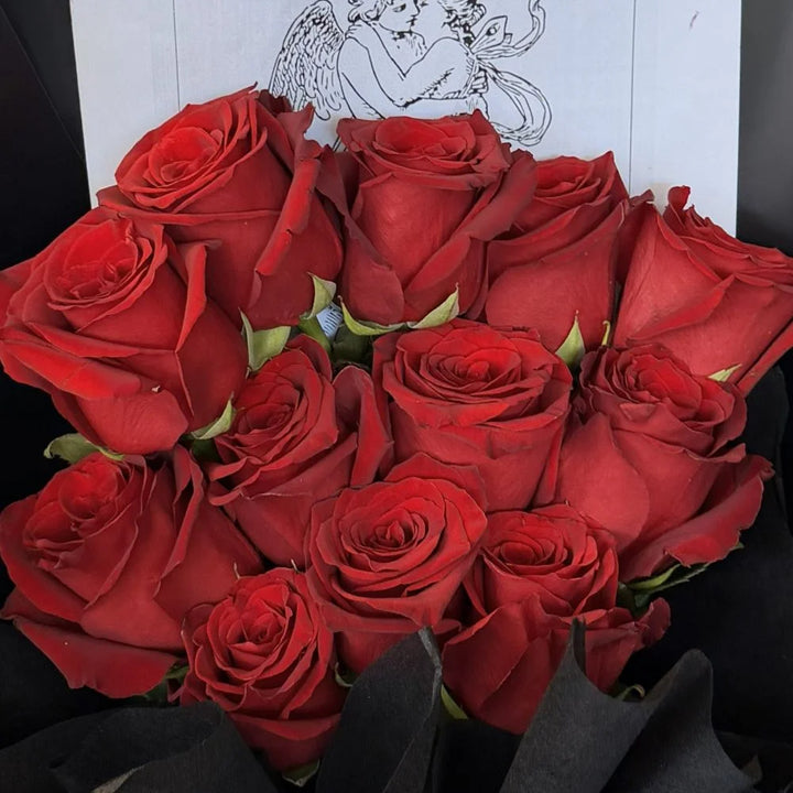 Close-up of 12 luxury red roses bouquet in black paper wrap with romantic gift card, Sydney same-day luxury red rose delivery by Vhouse Florist
