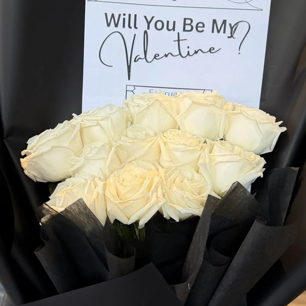 Close-up of 12 white roses bouquet in black paper with romantic gift card, Sydney same-day luxury white rose delivery by Vhouse Florist