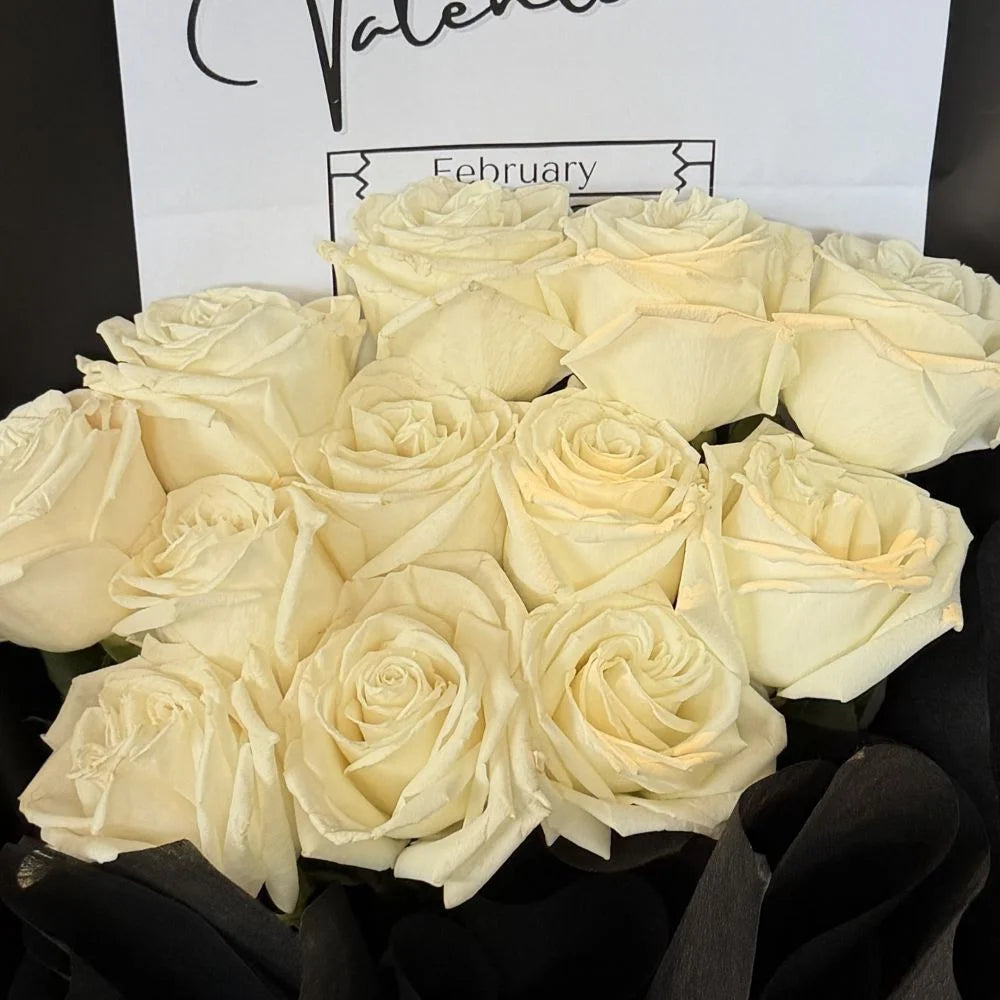Close-up of 12 white roses bouquet in black paper with romantic gift card, Sydney same-day luxury white rose delivery and elegant flower gifts by Vhouse Florist