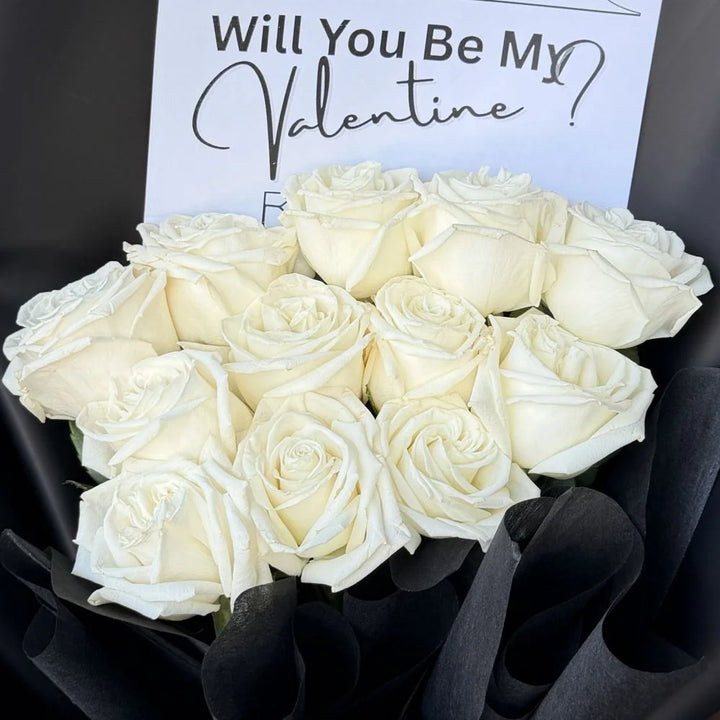 Close-up of 12 white roses bouquet in black paper wrap with romantic gift card, Sydney same-day luxury white rose delivery and elegant flower gifts by Vhouse Florist