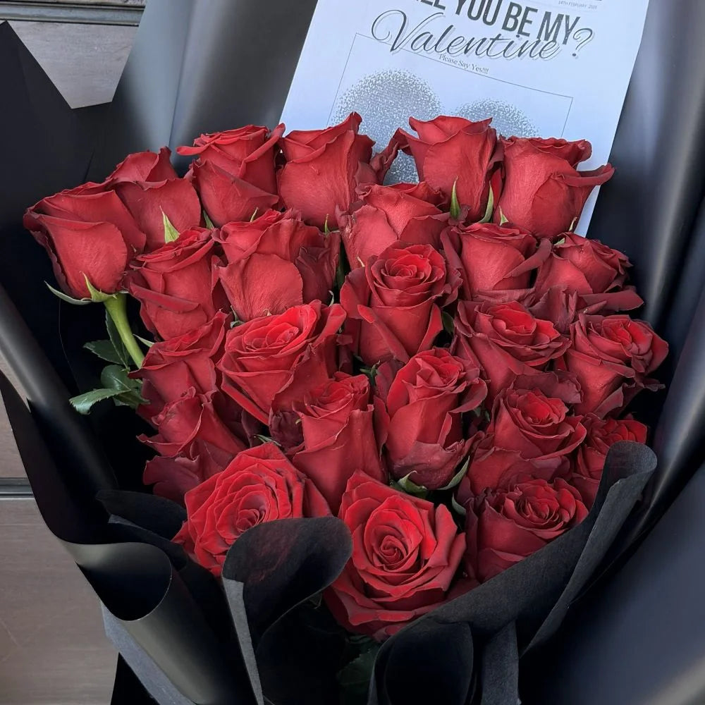 Close-up of 24 luxury red roses bouquet wrapped in black paper with romantic gift card, Sydney same-day luxury red rose delivery by Vhouse Florist