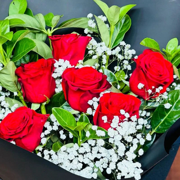Close-up overhead view of 6 red roses bouquet with baby&