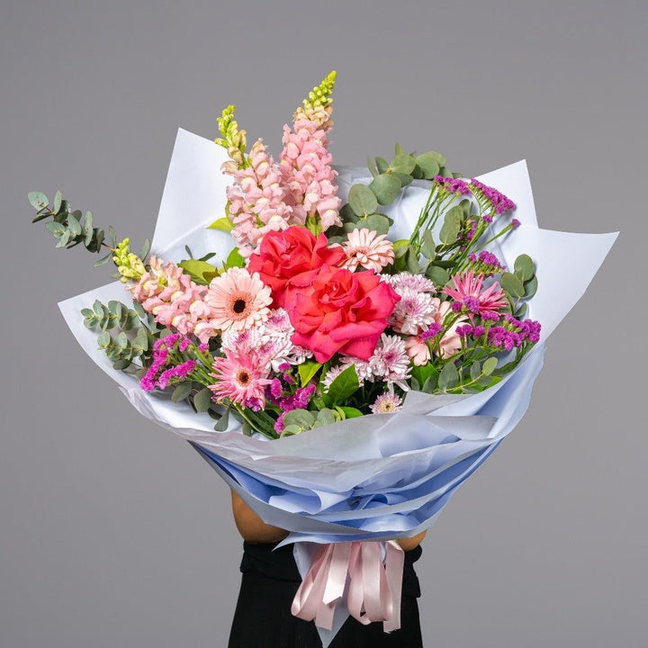 Flamingo bouquet with red roses and pink seasonal flowers by Vhouse Florist