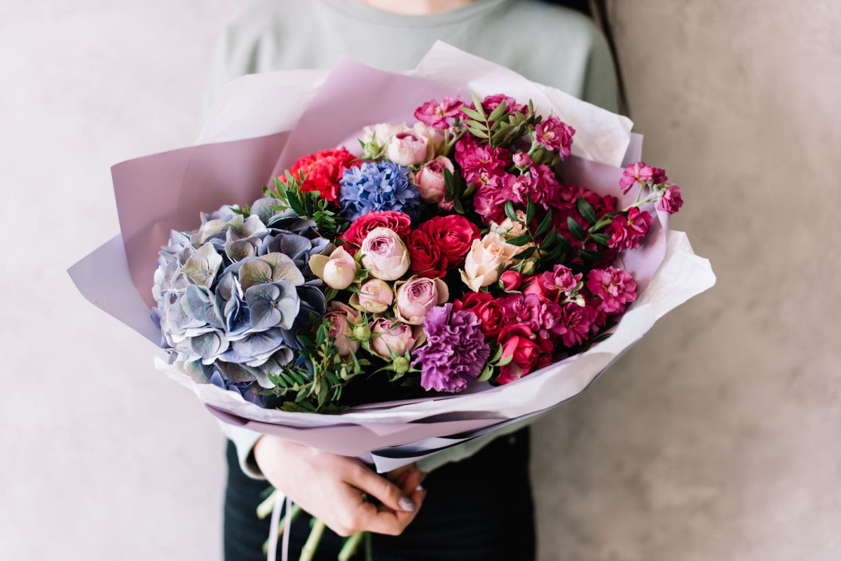 mixed flower bouquet of red, pink, purple and blue flowers