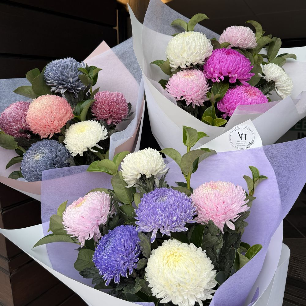 Three luxury chrysanthemum bouquets in purple, lilac, pink and white wrapped in pastel paper, Sydney same-day luxury flower delivery by Vhouse Florist