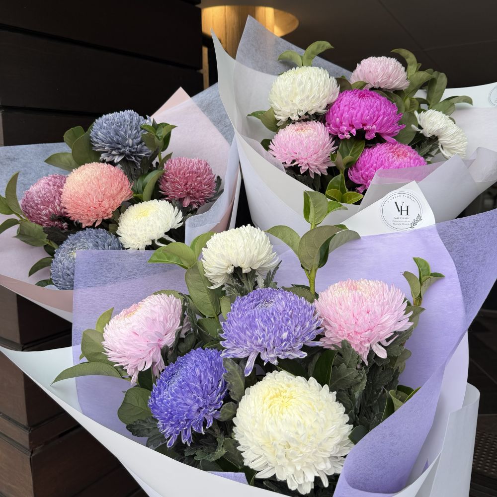 Three luxury chrysanthemum mum bouquets in purple, pink, blue and white wrapped in pastel paper, Sydney same-day luxury mum flower delivery by Vhouse Florist