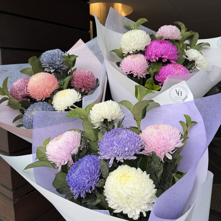 Three luxury chrysanthemum mum bouquets in purple, pink, blue and white wrapped in pastel paper, Sydney same-day luxury mum flower delivery by Vhouse Florist