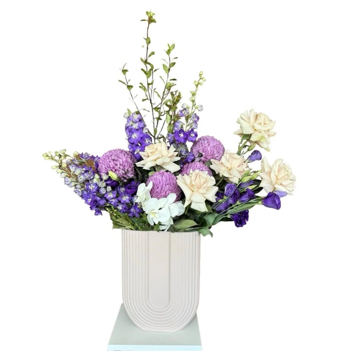 Purple and White flowers in white ceramic vase