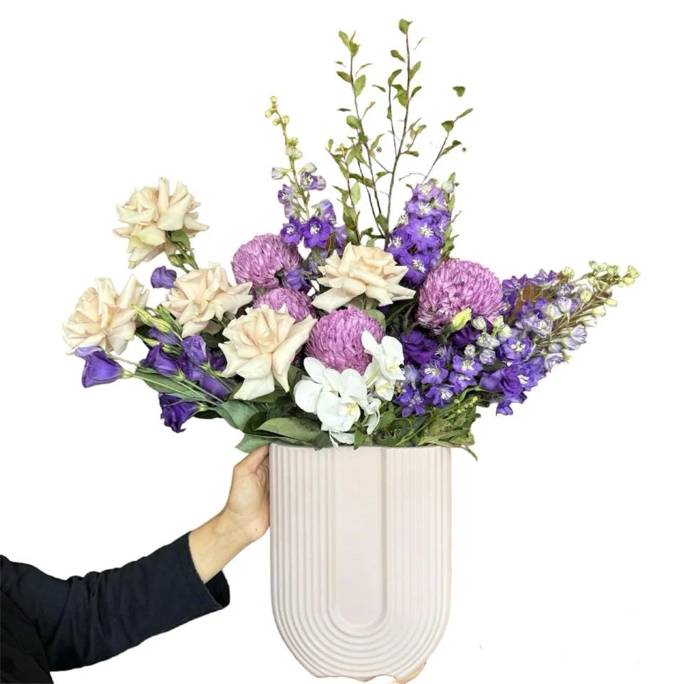 Purple and White flowers with greenery in white ceramic vase