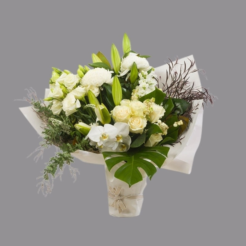 White flowers with greenery in paper wrap