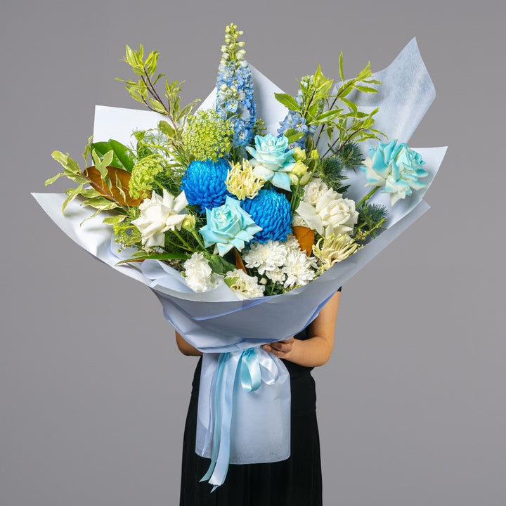 Grand Blue Sky bouquet with light blue and white flowers arranged by Vhouse Florist