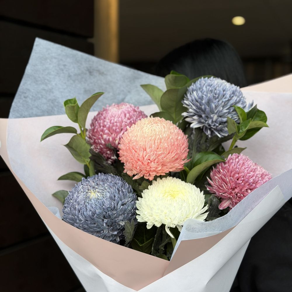 Close-up luxury chrysanthemum bouquet with blue, peach, pink and cream flowers wrapped in white paper, Sydney same-day luxury flower delivery by Vhouse Florist