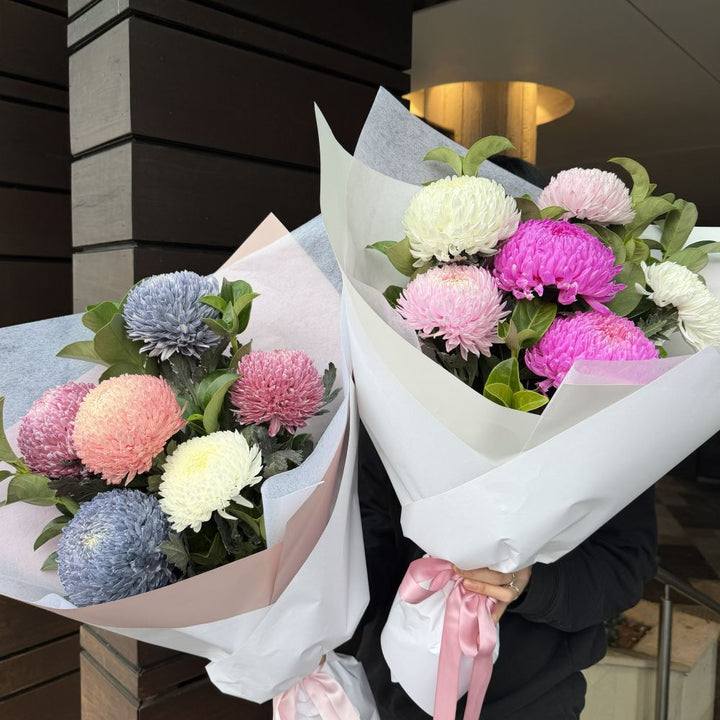 Two luxury chrysanthemum bouquets in blue, peach, pink and white wrapped in white paper with pink ribbon, Sydney same-day luxury flower delivery by Vhouse Florist