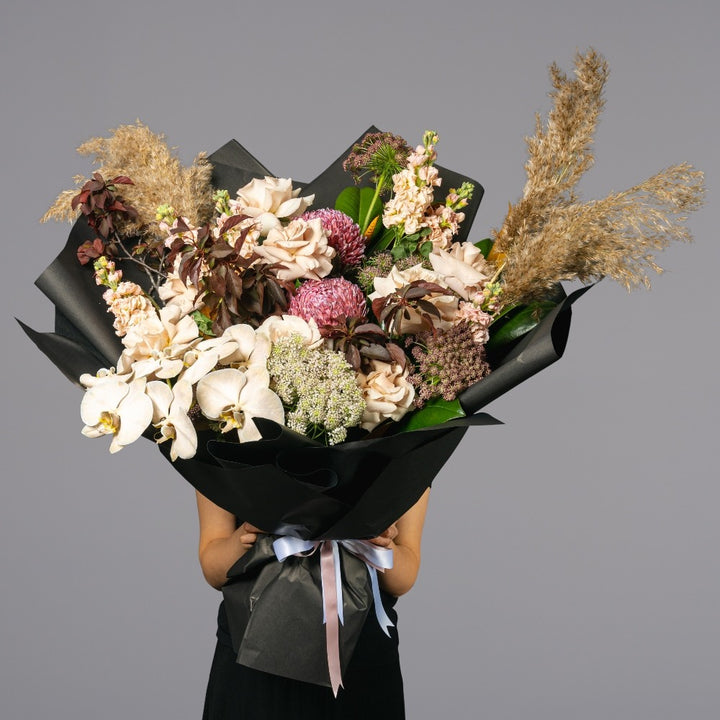 Mixed arrangement of fresh and native flowers including phally
