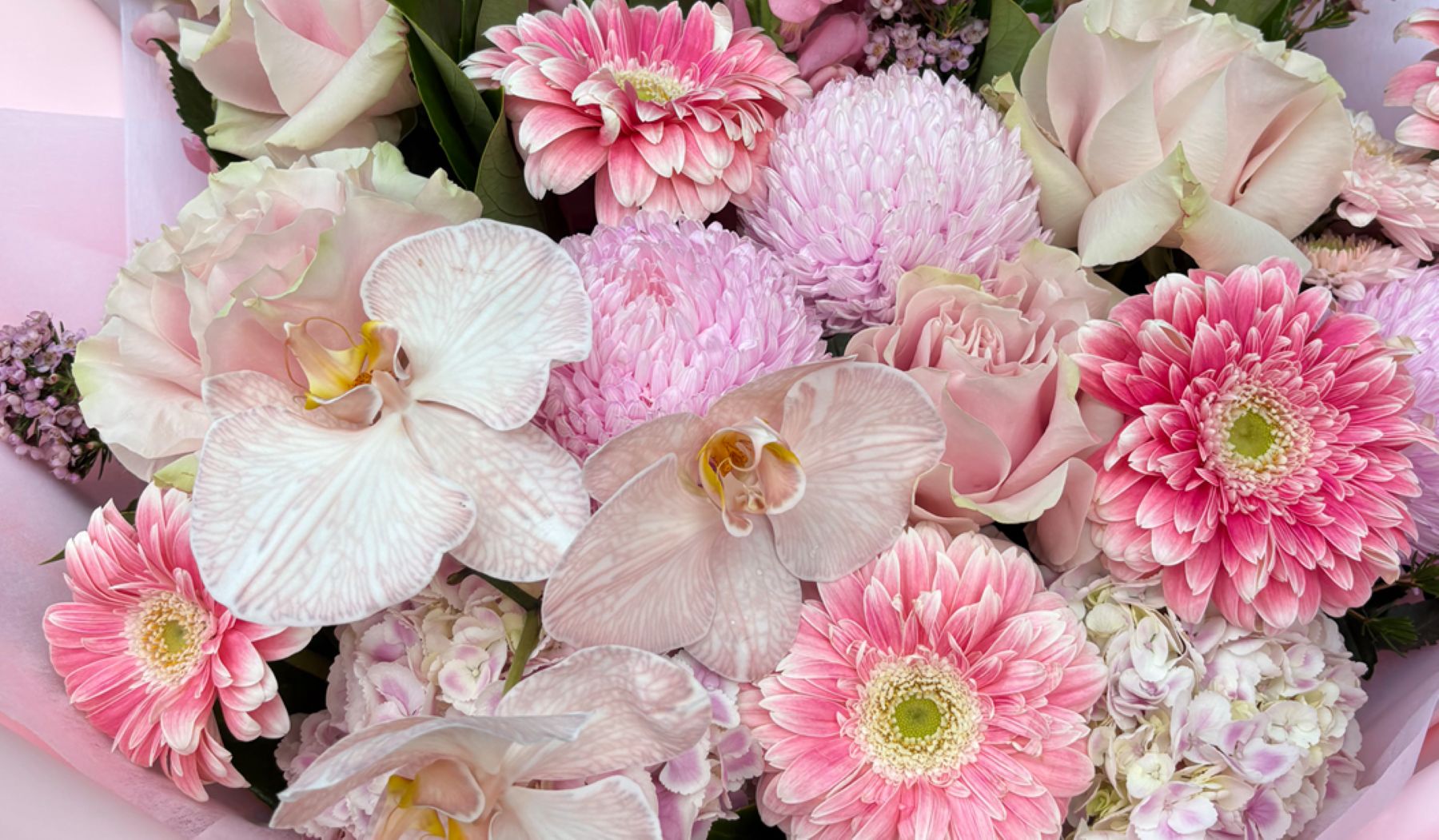 Pink flower arrangement featuring orchids, gerberas, pink chrysanthemums, roses and lisianthus in soft pink and white tones, Sydney luxury fresh flower delivery by Vhouse Florist