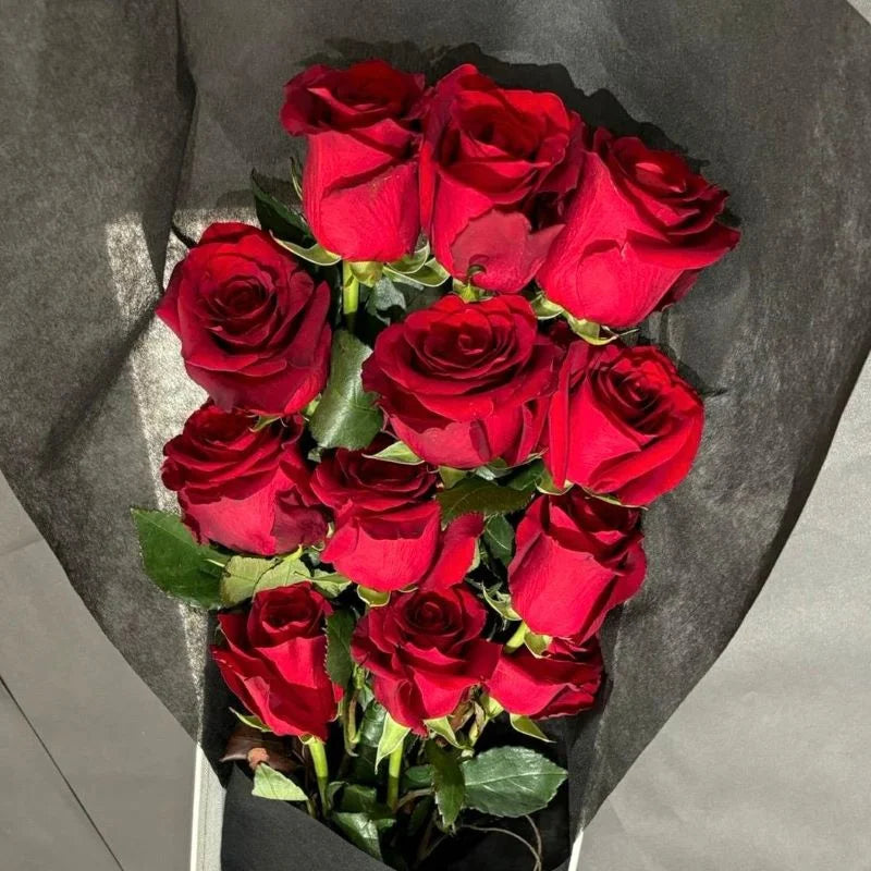 Close-up overhead view of red roses arranged in black gift wrap, Sydney luxury red rose delivery and romantic flower gifts by Vhouse Florist