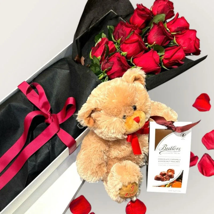Luxury romantic gift set with red roses in black wrap, teddy bear and chocolates on silver background, Sydney same-day luxury flower and gift delivery by Vhouse Florist