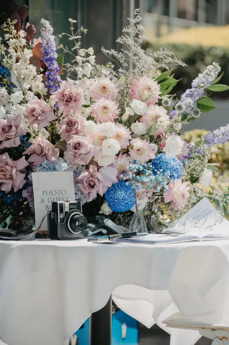 Guest book table flowers with soft pastel blooms