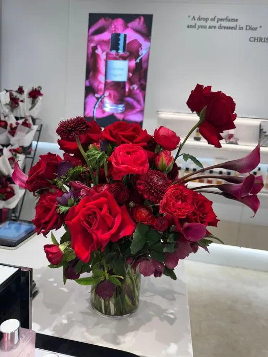 Red rose, dahlia and calla lily arrangement on a counter in a Dior beauty boutique in Sydney