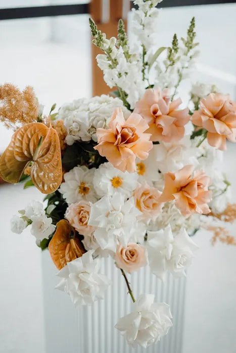 Apricot and ivory wedding plinth arrangement with peach roses, white snapdragons and anthuriums, Sydney wedding florist